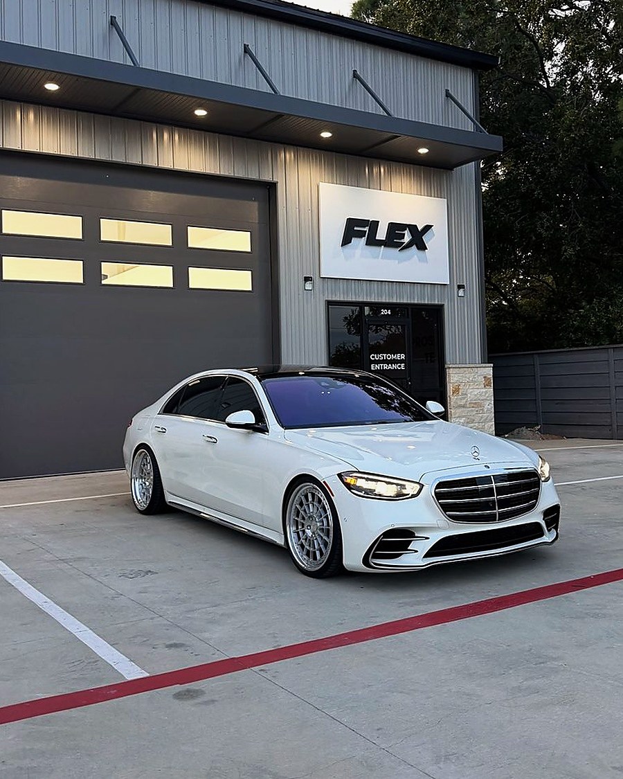 White Mercedes S-Class in front of the FLEX shop