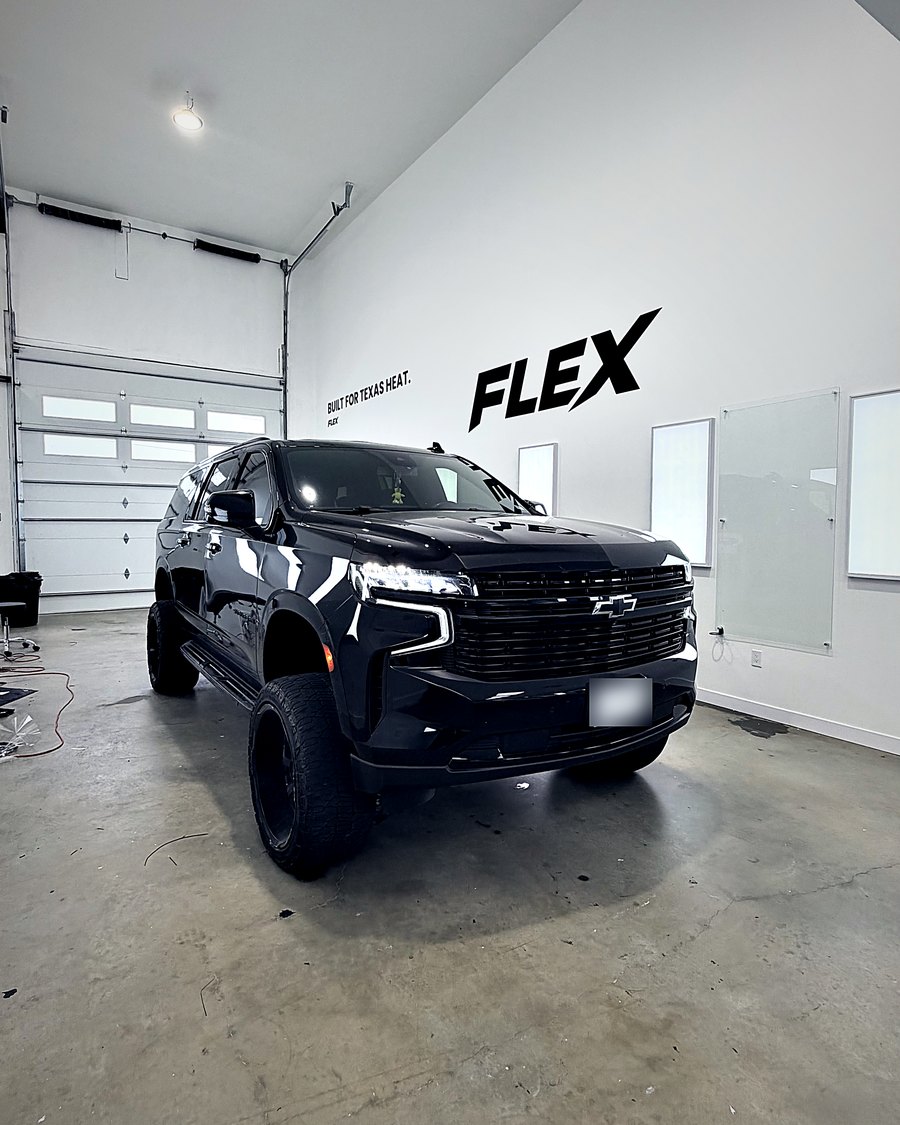 Black Chevy Tahoe in the FLEX shop